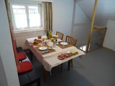 a table with food and wine on it in a room at 22 – Zimmer & Zmorge in Kreuzlingen