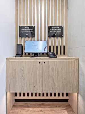 a desk with a laptop computer on top of it at MOOI Apartments St.Gallen in St. Gallen