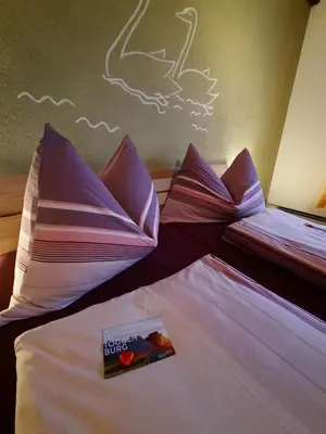 a hotel room with two beds with a book on them at Ferienwohnung Schafbergblick in Wildhaus