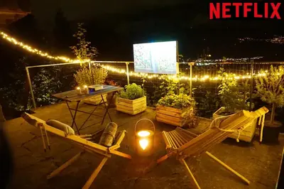 a patio with a table and chairs and lights at HERZLI-CHALET über dem Rheintal mit Schlossblick in Werdenberg