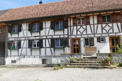 a white building with a sign on the side of it at Family Landhaus Birwinken in Berg