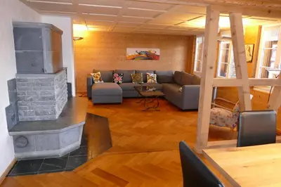 a kitchen with wooden cabinets and a table and chairs at Family Landhaus Birwinken in Berg