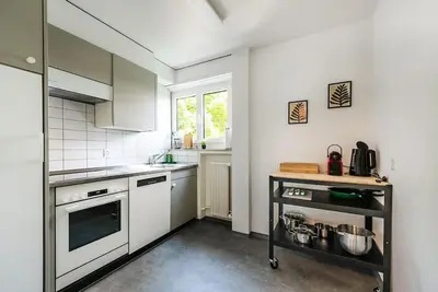 a kitchen with white appliances and a window at SOHO 12 !Gratis Parken, Free Parking! in Kreuzlingen