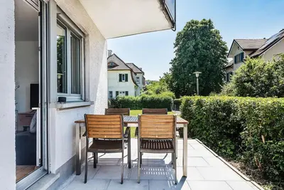 a table and chairs sitting on the porch of a house at SOHO 12 !Gratis Parken, Free Parking! in Kreuzlingen