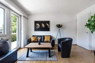 a living room with a couch and a table at SOHO 12 !Gratis Parken, Free Parking! in Kreuzlingen