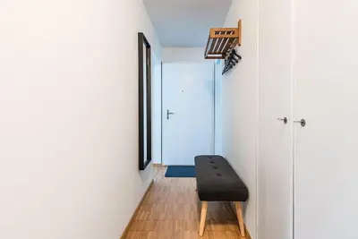 a black chair sits in a room with a door at SOHO 12 !Gratis Parken, Free Parking! in Kreuzlingen
