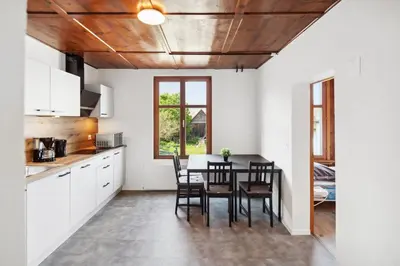 a kitchen and dining room with a table and chairs at FENUS Apartment mit traumhaftem Bergblick SGT02 in Grabs