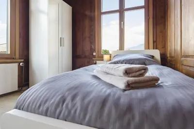 a bedroom with a bed with towels on it at FENUS Apartment mit traumhaftem Bergblick SGT02 in Grabs