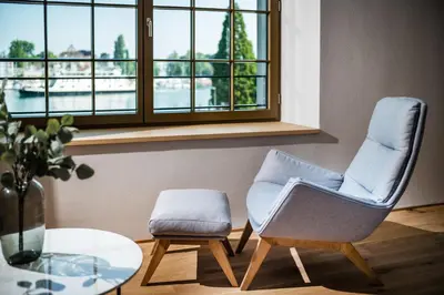 two chairs and a table in a room with a window at Business Appartement 3 am Bodensee in Romanshorn