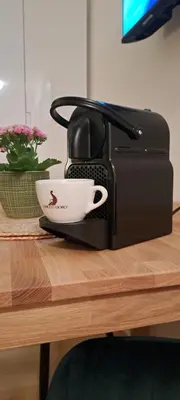 a coffee maker with a cup on top of a table at Sonniges 1-Zimmerappartement mit Blick über Kreuzlingen in Kreuzlingen