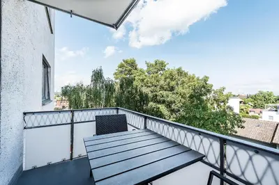 a balcony with a table and a chair on it at SOHO 6 !Gratis Parken, Free Parking! in Kreuzlingen