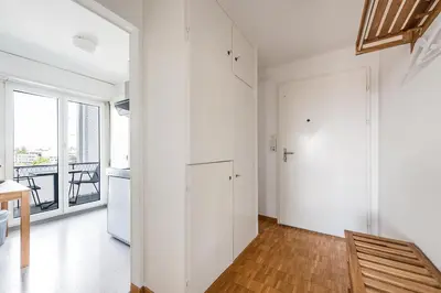 a white apartment with a hallway with a door at SOHO 6 !Gratis Parken, Free Parking! in Kreuzlingen