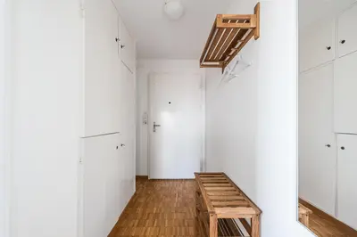 a hallway with white cabinets and a wooden bench at SOHO 6 !Gratis Parken, Free Parking! in Kreuzlingen
