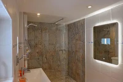 a bathroom with a shower and a sink at Ferienwohnung im Grünen in Altstätten