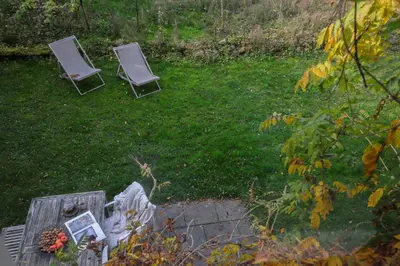 two chairs sitting in a yard with a table at Ferienwohnung im Grünen in Altstätten