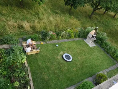 an aerial view of a garden with a dog sitting in a bench at Haus St.Michael in Dozwil