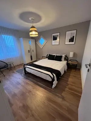 a bedroom with a large bed in a room at Black&White Apartment in Uzwil