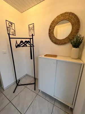 a dressing room with a mirror and a dresser at Black&White Apartment in Uzwil