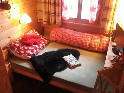 a dark room with a group of chairs and lights at IB Säntis Chalet Chnorz Rooms in Nesslau