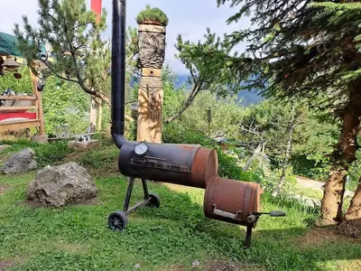 an outdoor object with a fire hydrant in the grass at IB Säntis Chalet Chnorz Rooms in Nesslau