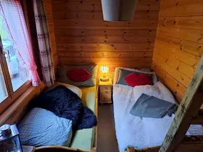 a living room with a couch and a table at IB Säntis Chalet Chnorz Rooms in Nesslau