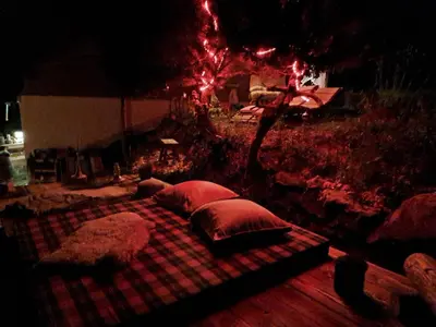 a large bed with pillows on a plaid blanket at IB Säntis Chalet Chnorz Entire House in Nesslau