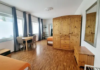 a room with a bedroom with a bed and a table at Treffpunkt Heuwiese in Weite
