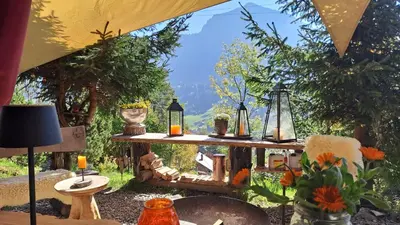 a room with a table with vases and a window at IB Säntis Chalet Chnorz Apartment in Nesslau