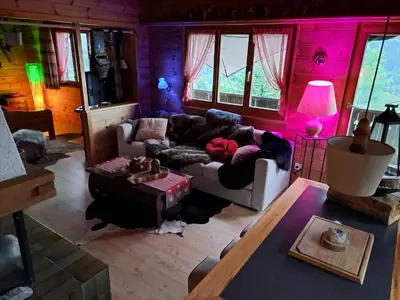 a living room with a couch and a table at IB Säntis Chalet Chnorz Apartment in Nesslau