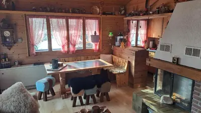 a kitchen with a table and chairs in a cabin at IB Säntis Chalet Chnorz Apartment in Nesslau