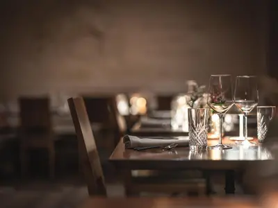 a wooden table with glasses of wine on it at Dorfhus Gupf in Rehetobel