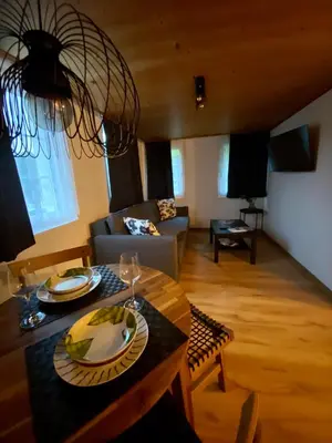 a living room with a table and a couch at Ferienwohnung in Stein AR in Stein