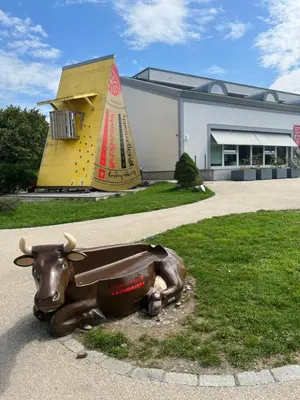 a statue of a cow on the grass in front of a building at Ferienwohnung in Stein AR in Stein