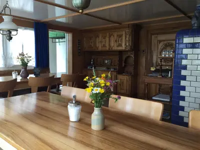 a dining room table with a vase of flowers on it at Hirschen Wald - Gasthaus & Bäckerei in Wald
