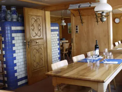 a dining room with a wooden table and chairs at Hirschen Wald - Gasthaus & Bäckerei in Wald