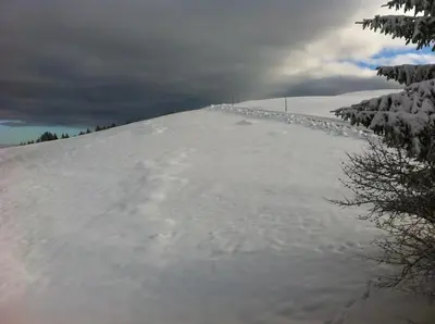 a snow covered hill with a fence on top of it at Hirschen Wald - Gasthaus & Bäckerei in Wald