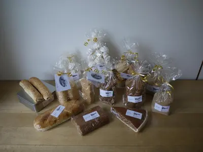 a group of breads and pastries in plastic bags on a table at Hirschen Wald - Gasthaus & Bäckerei in Wald