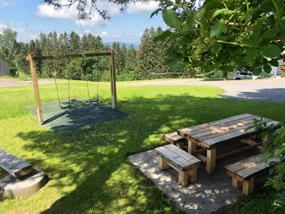 a park with a picnic table and a swing at Hirschen Wald - Gasthaus & Bäckerei in Wald
