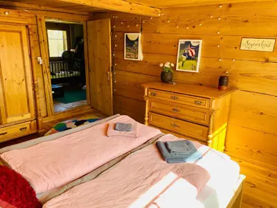 a bedroom with two beds and a dresser in a cabin at Birkenhof, Haus Märli in Herisau