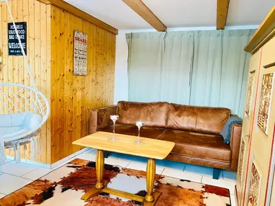 a living room with a couch and a table at Birkenhof, Haus Schwänli in Herisau