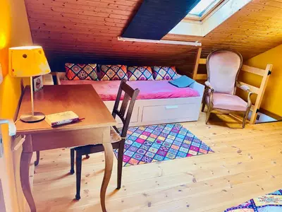 a room with a desk and a bed and a table at Birkenhof, Haus Schwänli in Herisau