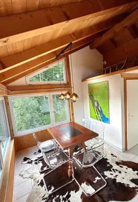 a table and chairs in a tiny house at Wunderschöne Maisonette-Ferienwohnung in stattlichem Toggenburgerhaus in Sankt Peterzell