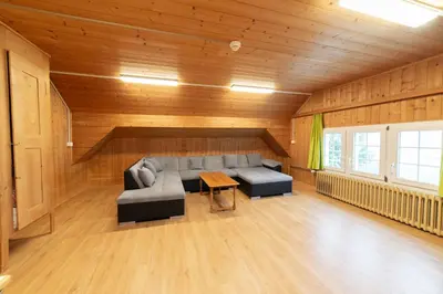 a living room with a couch and a table at Ferienheim Bodenweidli in Wildhaus