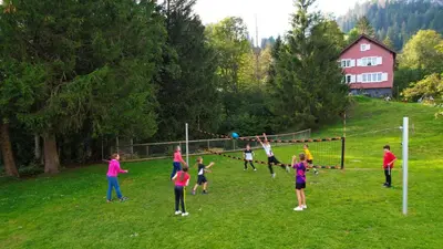 a group of children playing a game of volleyball at Ferienheim Bodenweidli in Wildhaus