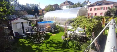 an image of a garden with a greenhouse at Bijou 1 Hübsche 1 Zimmer Wohnung in Herisau