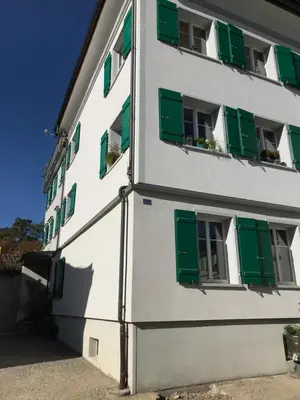a building with green shutters on it at Bijou 1 Hübsche 1 Zimmer Wohnung in Herisau