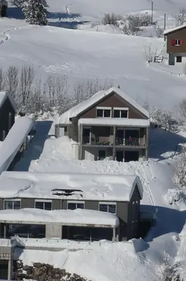 a house is covered in snow at Studio Bijou in Unterwasser