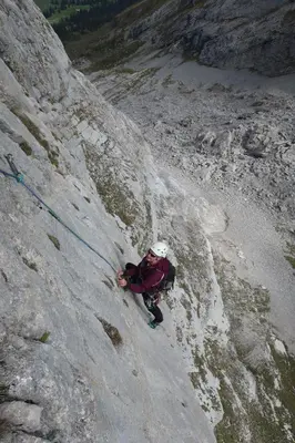 a man climbing a snowy mountain with a backpack at Studio Bijou in Unterwasser