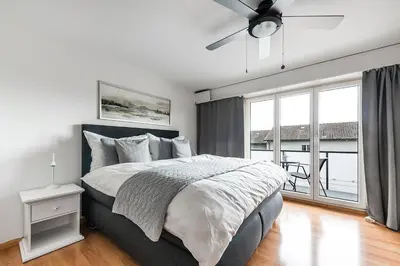 a bedroom with a large bed and a large window at SOHO 3B !Gratis Parken, Free Parking! in Kreuzlingen