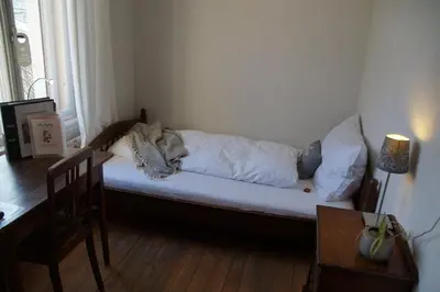 a dog sleeping on a couch in a living room at Villa Donkey BnB in Degersheim